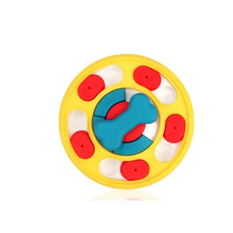 Dog puzzle feeder in yellow with red sliding covers and a blue bone-shaped centre, on a white background.