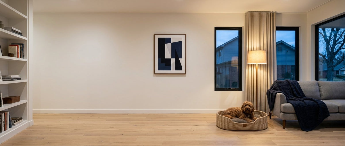 Cavoodle resting calmly on a dog bed in a cosy living room